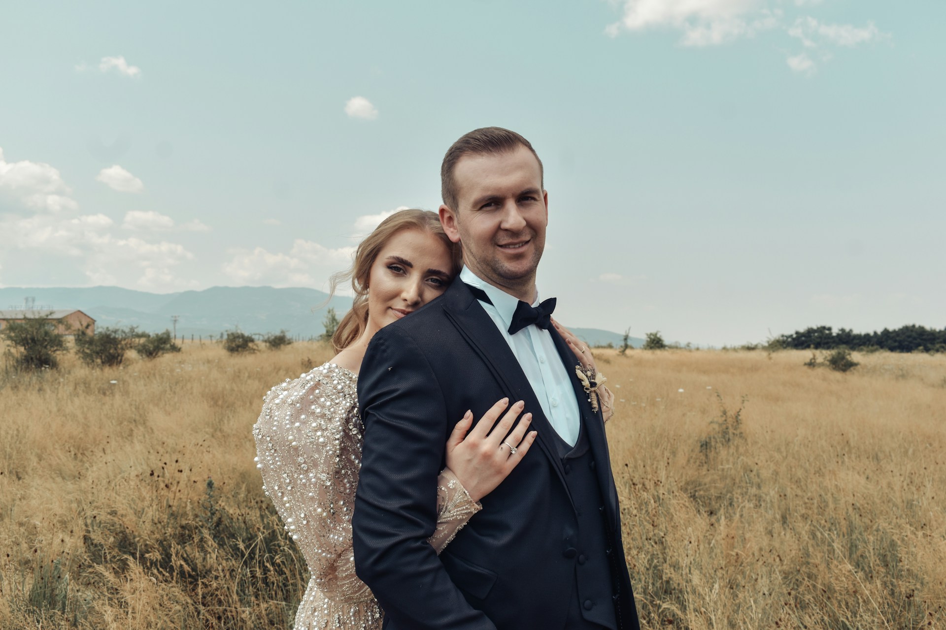a man and a woman holding hands in a field